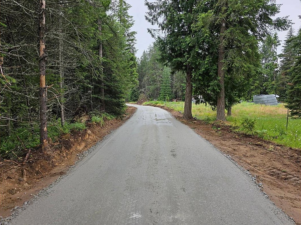 Finished gravel driveway through North Idaho forest by Improvements Unlimited