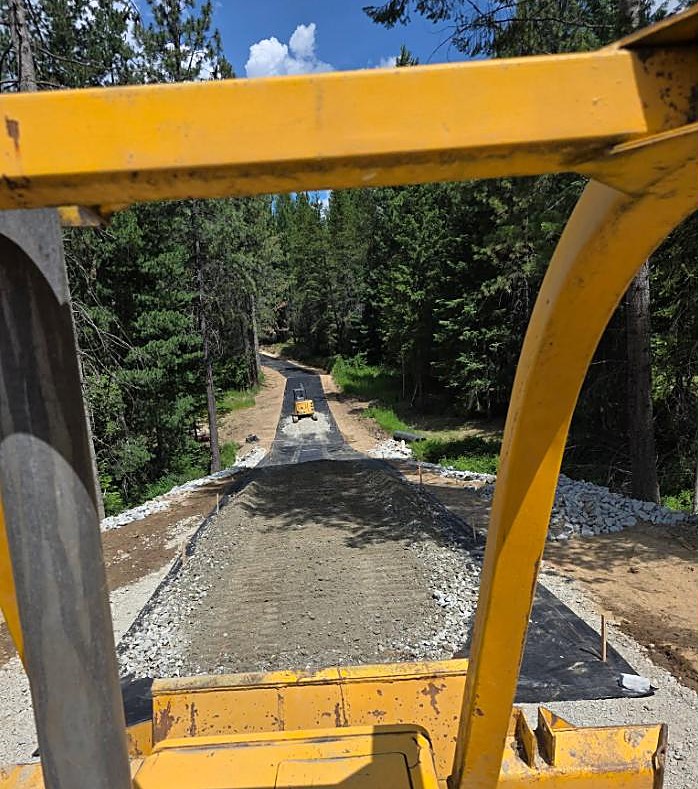 Building a gravel road through North Idaho forest, view from the machine cab